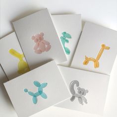 four cards with different colored animals on them