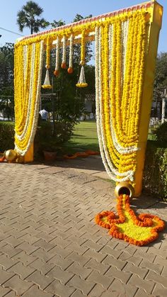 an outdoor ceremony with yellow and orange decorations