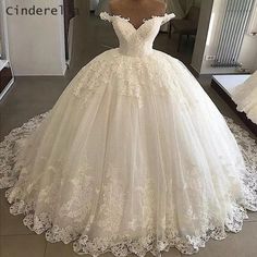 a white wedding dress on display in front of a mirror