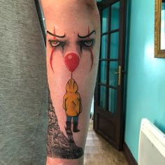 a man's leg with a tattoo of a clown and a red balloon on it