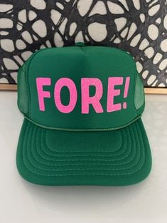 Fore Kelly Green Trucker hat with pink glitter font. 100% Polyester Front 100% Polyester Mesh Back The Traditional Look 5-panel cap Seamless Foam Front Panel with Lining Matching Color Braid 8 Rows Stitching on Visor Matching Fabric Under visor Matching Color Sweatband Plastic Adjustable Snap OSFM - Adult (6 1/2 - 7 5/8) Cheap Green Trucker Hat For Outdoor Activities, Green Trucker Hat, Kelly Green, Pink Glitter, Trucker Cap, Color Matching, Caps Hats, Trucker Hat, The Row