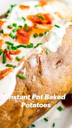 a close up of a baked potato on a plate with sour cream and chives