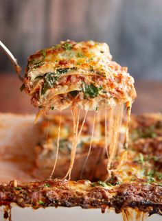 a slice of lasagna being lifted with a fork