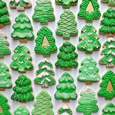 green decorated cookies with trees and snow on them