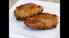 two pieces of fried food on a white plate