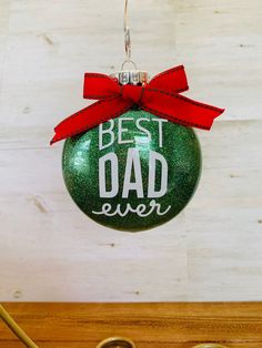 a green ornament with the words best dad ever on it