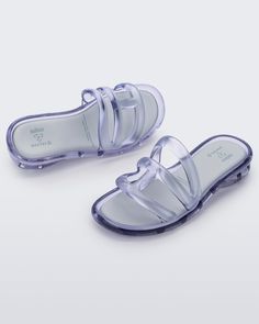 Runs large - if you're in-between sizes, please size down. The Melissa x Telfar Jelly Slide — features a tubular design forming a logo strap before snaking around the foot and under the heel for a little lift. This slide is an instant icon molded using Melissa's exclusive Melflex material. Punk Love, Jelly Slides, Punk Movement, Clear Sandals, Gray Accessories, Funky Shoes, Viktor & Rolf, Jelly Shoes, Jelly Sandals