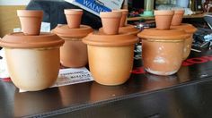 four clay pots sitting on top of a table