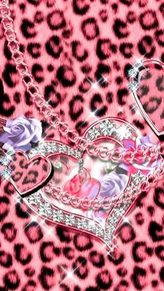 a heart shaped necklace with pink roses and hearts in the center on a leopard print background