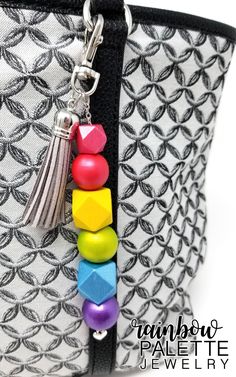 a handbag with beads and a tassel hanging from it