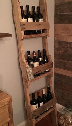 a wine rack made out of wooden pallets with bottles on the top and bottom