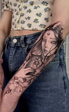 a woman's arm with flowers on it and her face in the middle of the arm