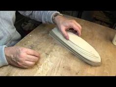 a person using a sanding board on top of a wooden table