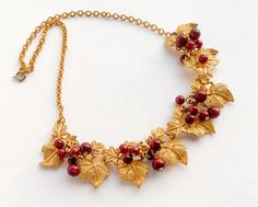 ~ 1950s beautiful gold grapes leaves necklace ~ Brushed gold intricate leaves ~ Dark red bead balls on each leaf ~ Very nice gold metal backing ~ Excellent necklace Length- 18.5" (47 cm) Width- 1"  (2.54 cm) Additional Vintage Jewelry in our sister shop Glenna's Jewels: http://glennasjewels.etsy.com More Incredible Vintage: http://glennasvintageshop.etsy.com Instagram @glennas_clothing Facebook https://www.facebook.com/glennasclothing Grapes Leaves, Leaves Necklace, Leaf Necklace, Choker Necklaces, Red Bead, Grape Leaves, Gold Gold, Dark Red, Gold Metal