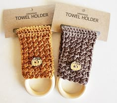 two crocheted towel holders sitting next to each other