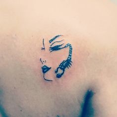 a woman's chest with a tattoo design on her left shoulder and the face of a lady