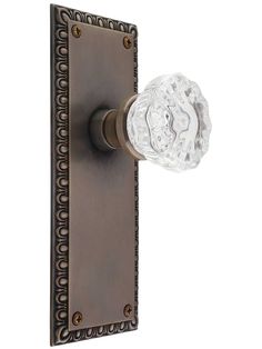 an antique style door handle with glass knob