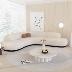 a modern living room with white furniture and art work on the wall behind the couch