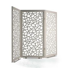 a white room divider with an intricate design