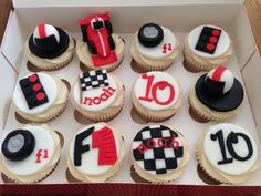 twelve cupcakes in a box decorated with racing gear and number one on them