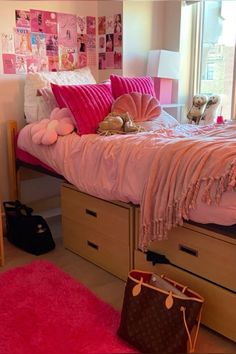 a bedroom with pink bedding and lots of pillows