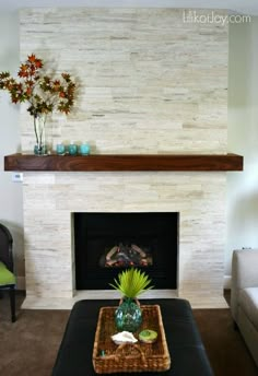 a living room with a couch, coffee table and fireplace