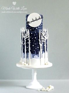 two cakes decorated to look like they have trees on them and the moon in the sky