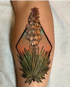 a person with a tattoo on their leg and some flowers in the middle of it