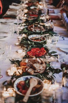 a long table with many plates and glasses on it