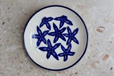 a blue and white plate with small stars on it