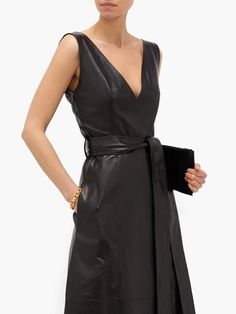 Explore our Women's Genuine Soft Lambskin Leather V-Neck Dress in black. Featuring a knee-length cut, belted waist, and deep V-neck, this handmade dress is available in all sizes and colors. Ideal for formal and casual wear, custom made for a perfect fit. Timeless Elegance in Soft Lambskin Introducing our Women's Genuine Soft Lambskin Leather V-Neck Dress in classic black. This stunning dress combines timeless elegance with modern sophistication, making it an essential piece for any wardrobe. Crafted from the finest soft lambskin leather, it offers a luxurious feel and a sleek appearance that is perfect for both formal and casual occasions. The knee-length cut and deep V-neck design add a touch of allure, ensuring you turn heads wherever you go. Flattering Fit with Belted Waist Designed to Sleeve Less Dress, Wear Black Dresses, Leather Dress Women, Black Leather Dress, Casual Formal Dresses, Black Leather Dresses, Dress Leather, Cocktail Evening Dresses, Vintage Party