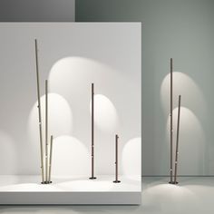 three different views of the same object, one in white and one in brown with long poles