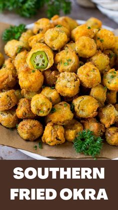 a white plate topped with fried food and garnished with parsley on top