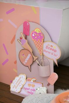 there are some ice cream and donuts on the table next to this card holder