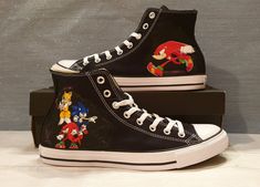 Stand out from the crowd with these unique and exclusive custom designed Converse Hi Tops black canvas shoes! 100% beautifully hand-painted and splash-resistant Sonic themed canvas shoes. These would be perfect as a birthday gift, bride and groom wedding shoes or as a personalized gift! Each canvas shoe is uniquely designed and hand painted. There may be a slight variation in the colour or placement of the design, but I always make sure you will get a top quality design and finish.  The products Custom Hand-painted Black High-top Sneakers, Black Hand Painted Custom Sneakers With Round Toe, Black Low-top Sneakers With Custom Artwork, Black Casual Sneakers With Custom Artwork, Artistic Black Sneakers With Custom Artwork, Casual Customized Black Sneakers, Casual Black Customized Sneakers, Designed Converse, Groom Wedding Shoes