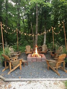 a fire pit surrounded by wooden chairs and lights