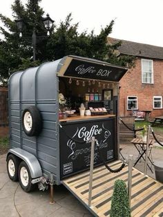 a small coffee cart is parked in front of a house