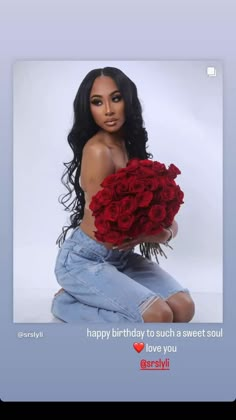 a woman sitting on the ground holding a bouquet of roses