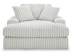 a white chair with two pillows on it's back and the seat upholstered