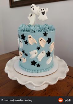 a blue cake decorated with ghost and stars