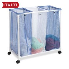 the laundry hamper is on wheels and has two mesh bags in front of it