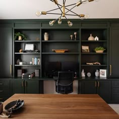 a large wooden table sitting in front of a book shelf filled with lots of books