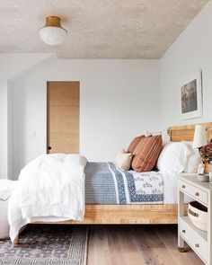 a bedroom with wood floors and white walls