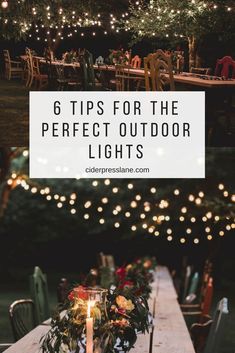 an outdoor table with candles and flowers on it, surrounded by lights in the background