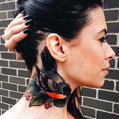 a woman with a bird tattoo on her neck