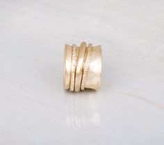 Spinner Ring ~ Solid 9K or 14K Gold Ring Handmade spinner ring made with wide concave ring hugged by three spinning rings.This is a fun unique ring that will add style and chic to any style.▸▸ Measurements◂◂- Ring Width: 16mm-17mm- Approx. height: 10mm – 23mm Also available in gold coating version:https://www.etsy.com/listing/77860963/▸▸ Size ◂◂Choose the ring size during checkout.You can use this site for easily measuring your size:http://findmyringsize.com/For 10+ size contact me to get a pric Yellow Gold Brass Wide Band Ring For Anniversary, Ring Spinning, Mixed Metal Rings, Spinning Ring, Thick Ring, Spinning Rings, Womens Ring, Chunky Ring, Meditation Rings