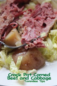 a white plate topped with corned beef and cabbage