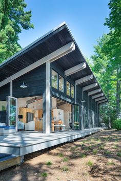 the instagram page shows an image of a house in the woods with lots of windows