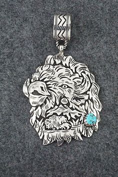 "This impressive Kingman turquoise and sterling silver pendant in the shape of a Buffalo was made by Navajo silversmith Richard Singer. The back is signed R Singer and stamped .925. Length: 4 3/8\" Width: 2 1/2\" Free shipping on all orders! We ship with USPS and always include tracking. All orders ship within a day of payment. Returns are accepted up to 30 days after you receive your order. Just send us a message. Our shop offers cash back or store credit. The item must be returned in new condi Western Style Silver Turquoise Necklace With Large Pendant, Engraved Silver Southwestern Turquoise Necklace, Engraved Silver Turquoise Necklace In Southwestern Style, Etched Turquoise Sterling Silver Jewelry, Western Style Collectible Turquoise Sterling Silver Necklace, Artisan Turquoise Necklace Stamped 925 Collectible, Engraved Turquoise Pendant Necklace, Collectible, Engraved Turquoise Pendant Necklace Collectible, Kingman Turquoise