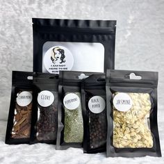 five bags filled with different types of nuts and spices on top of a white surface